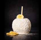 Banana pudding caramel apple topped with white chocolate drizzle and vanilla cookie crumbles