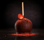 Chocolate covered strawberry caramel apple dipped in chocolate with strawberry drizzle and strawberry topping